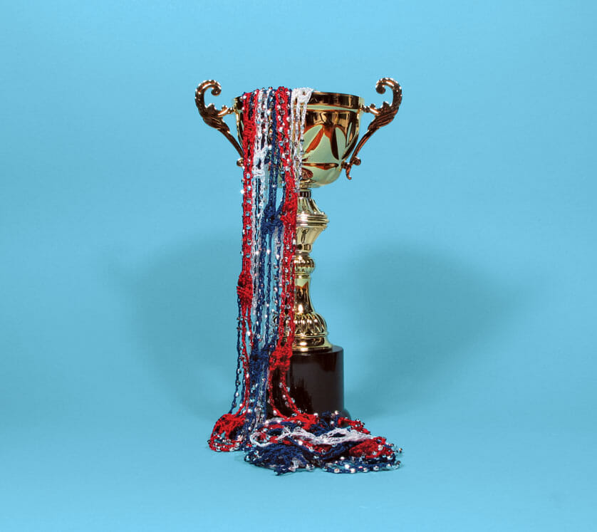 trophy with red, white, and blue streamers