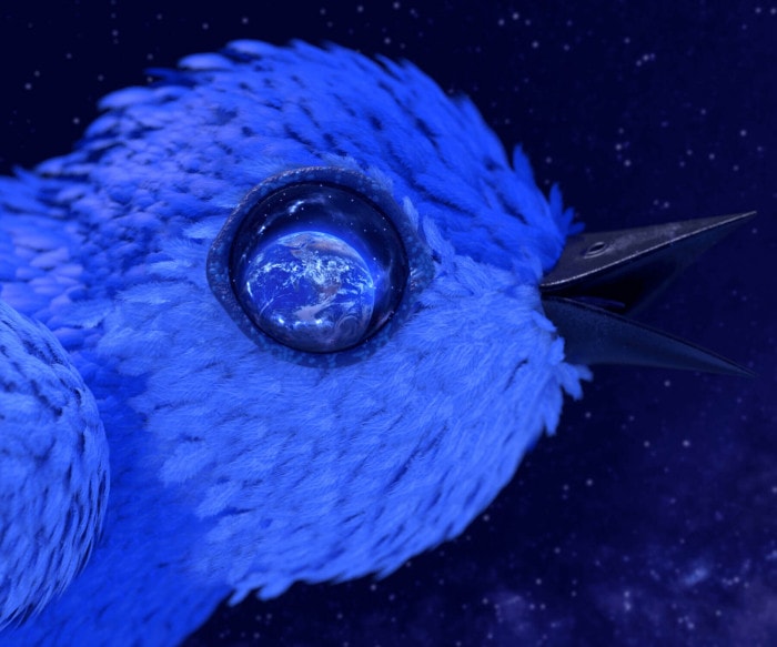 An eldritch depiction of the Twitter bird gapes its beak in the dark with a galaxy of stars in the background. The Earth is reflected in its eye.